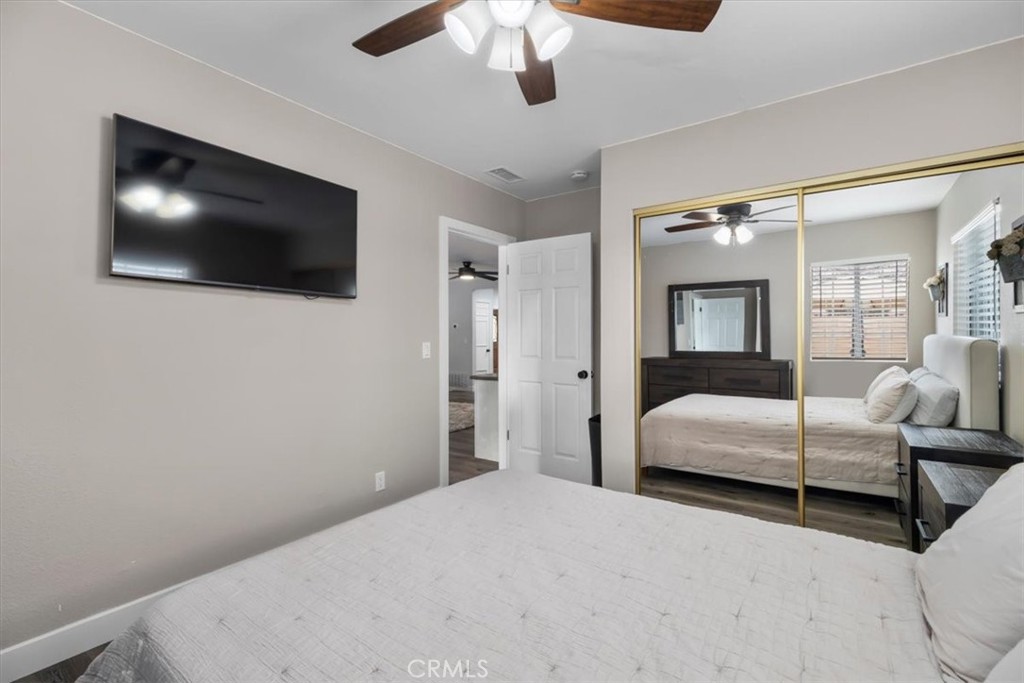 338 East 219th Street Carson, CA 90745 - Photo 15 of 36 a bedroom with a large bed and a flat screen tv