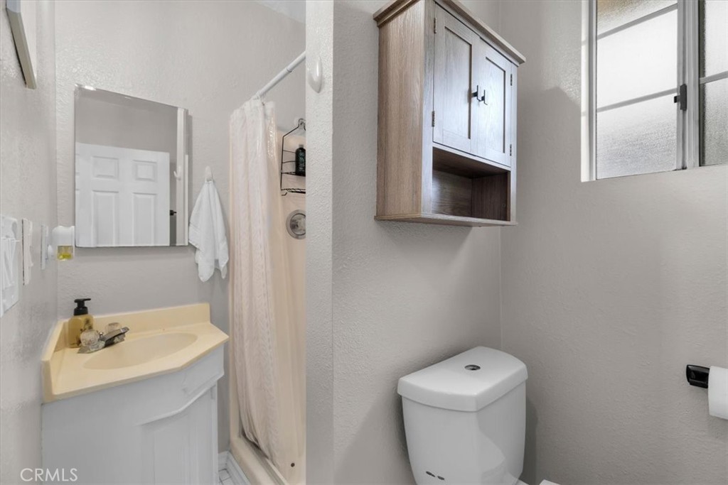 338 East 219th Street Carson, CA 90745 - Photo 18 of 36 a bathroom with a sink a toilet and shower