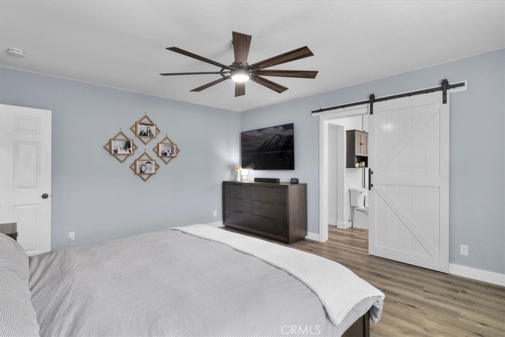 338 East 219th Street Carson, CA 90745 - Photo 23 of 36 a bedroom with a bed and a flat screen tv