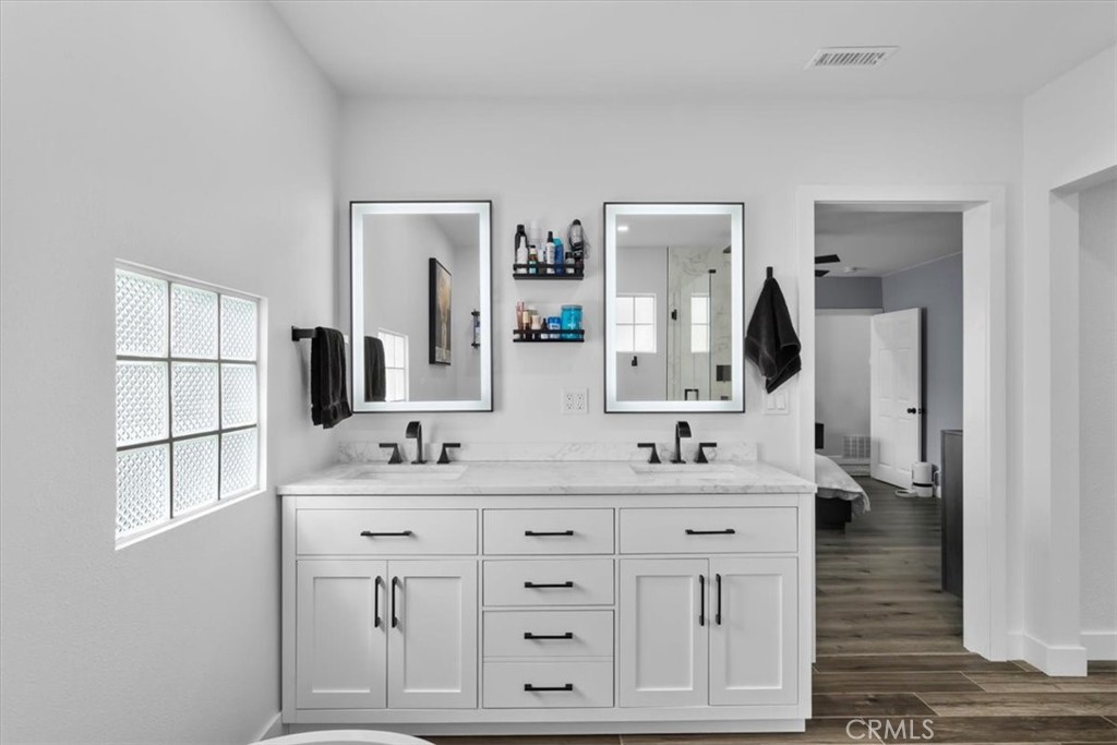 338 East 219th Street Carson, CA 90745 - Photo 25 of 36 a bathroom with double vanity sink a mirror and vanity