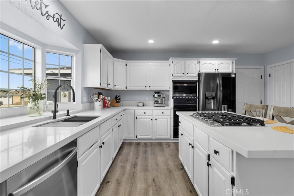 338 East 219th Street Carson, CA 90745 - Photo 7 of 36 a kitchen with stainless steel appliances granite countertop a sink stove and cabinets