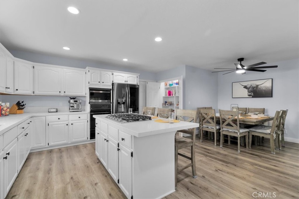 338 East 219th Street Carson, CA 90745 - Photo 8 of 36 a kitchen with stainless steel appliances a stove a sink dishwasher a oven with white cabinets and wooden floor