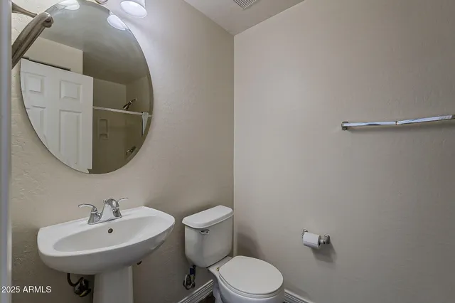 a bathroom with a sink a mirror and toilet