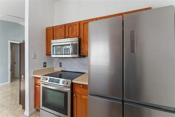 a kitchen with stainless steel appliances granite countertop a refrigerator and a sink
