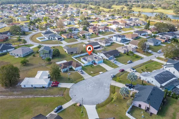 an aerial view of residential house with outdoor space and swimming pool