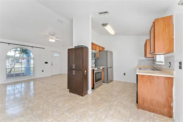 a kitchen with refrigerator and window