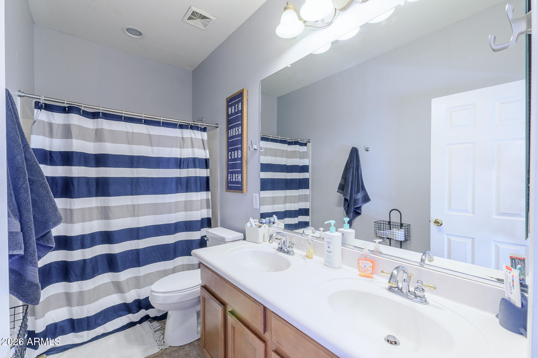 4521 West Moss Springs Road Anthem, AZ 85086 - Photo 32 of 35 a bathroom with a sink a toilet a shower and a mirror