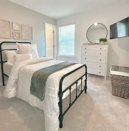 a bedroom with a bed and a dresser
