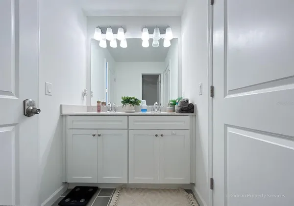 a bathroom with a sink and a mirror