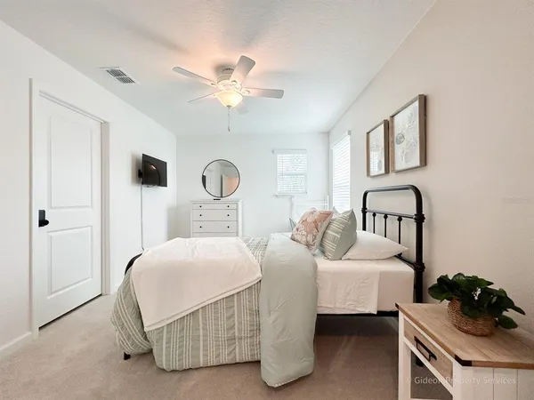 a bedroom with a bed and a chandelier