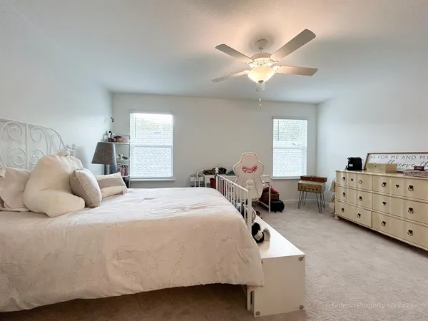 a bedroom with a bed and window