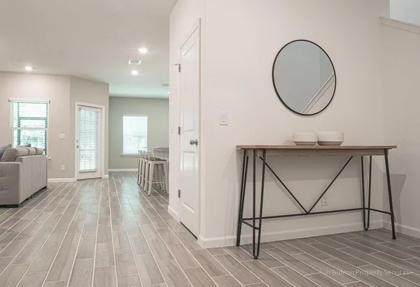 a view of a room with wooden floor and furniture
