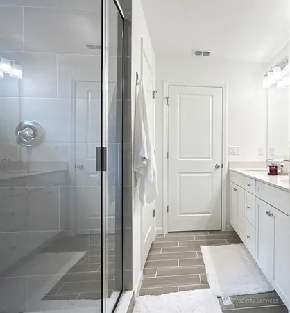 a bathroom with a shower and sink