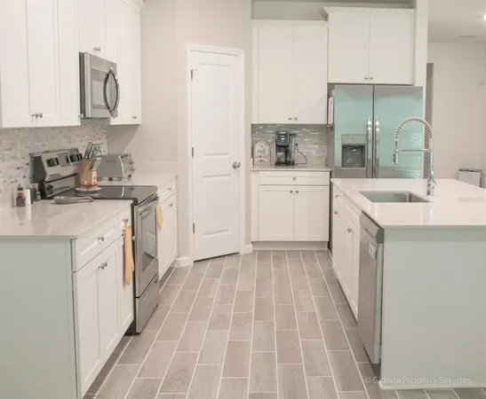 a kitchen with a sink stove and cabinets
