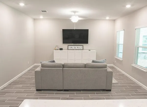 a living room with furniture and a flat screen tv