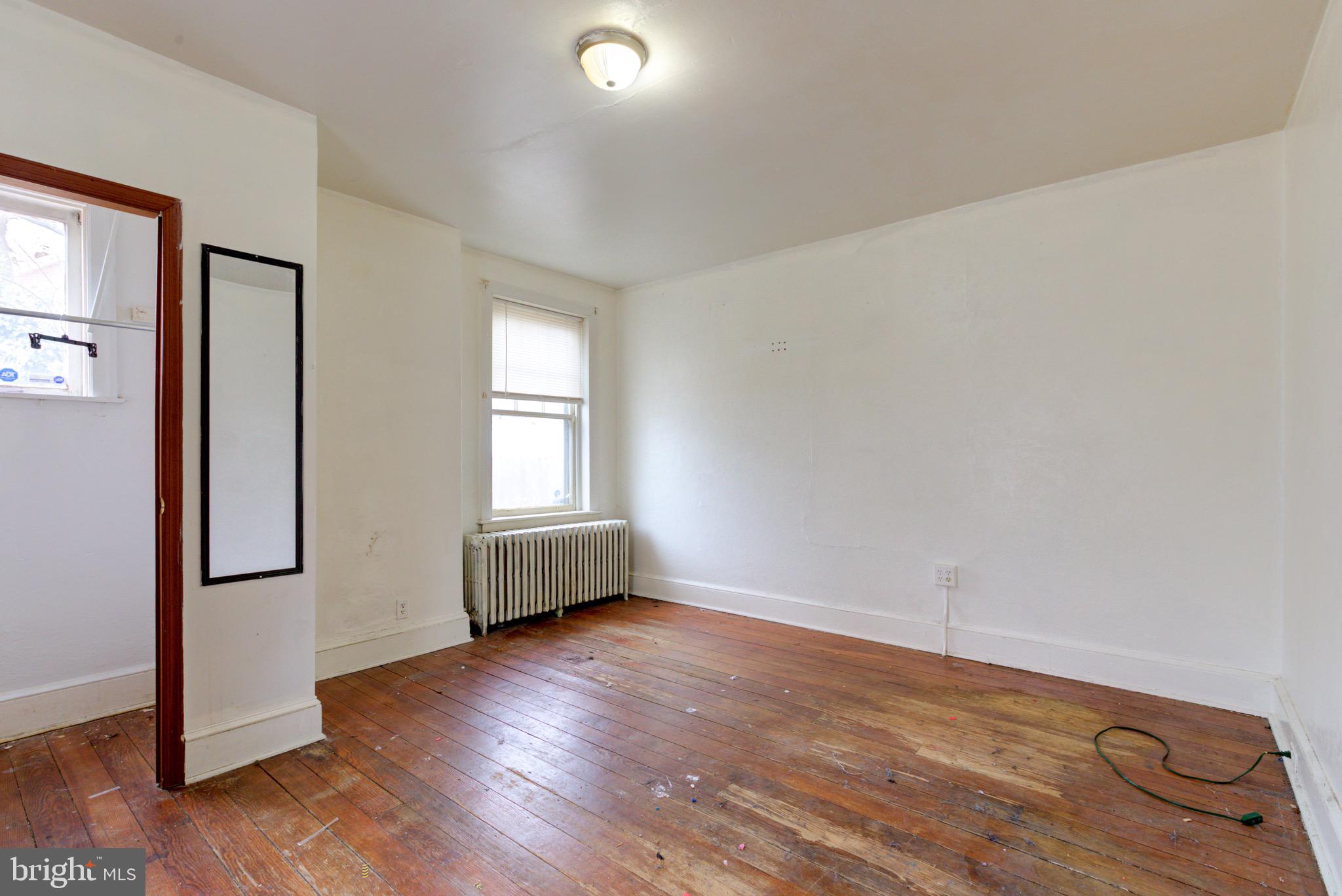 15 7th Street Brookhaven, PA 19015 - Photo 14 of 33 an empty room with wooden floor and windows