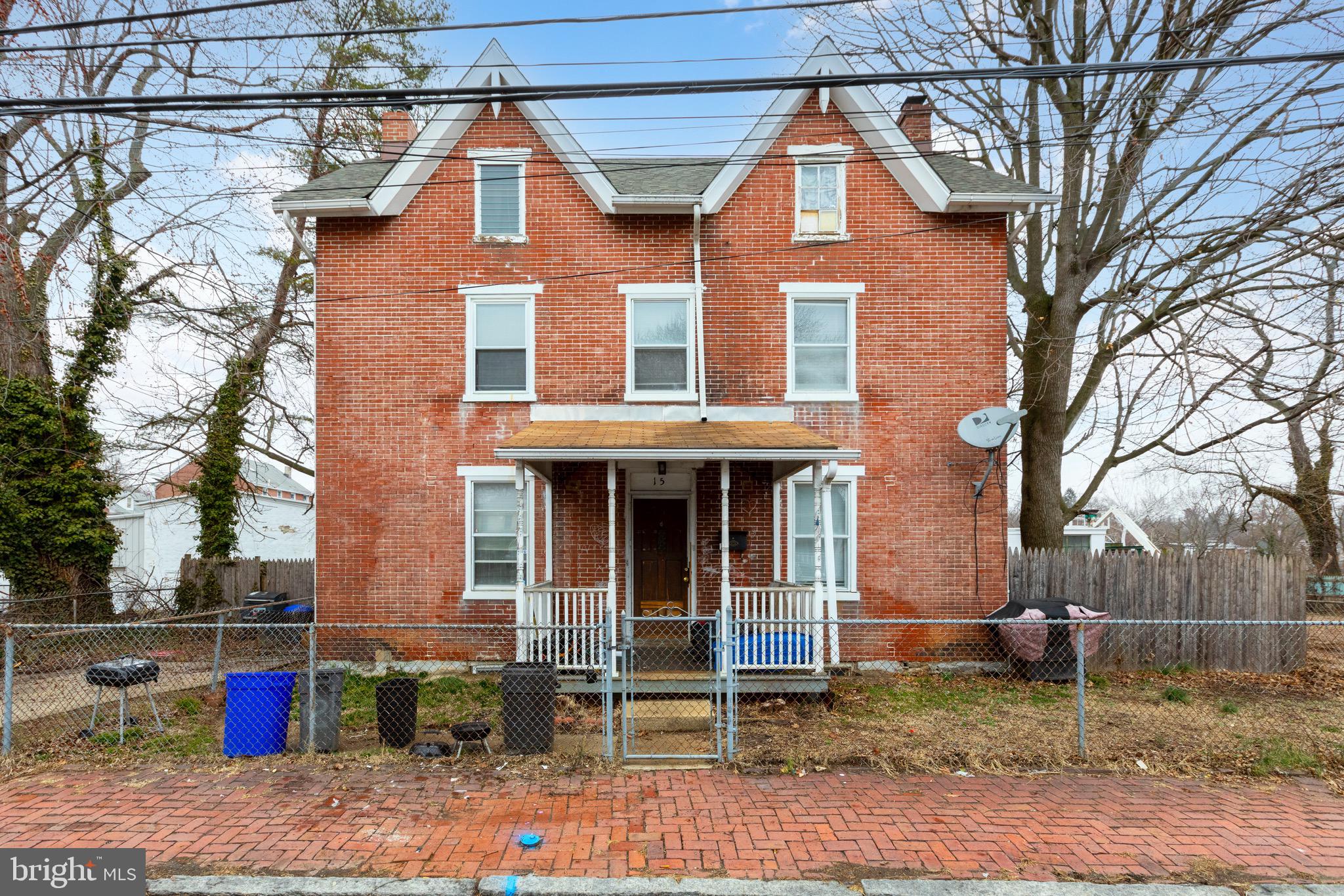 15 7th Street Brookhaven, PA 19015 - Photo 2 of 33 a view of brick house with large windows and a table and chairs