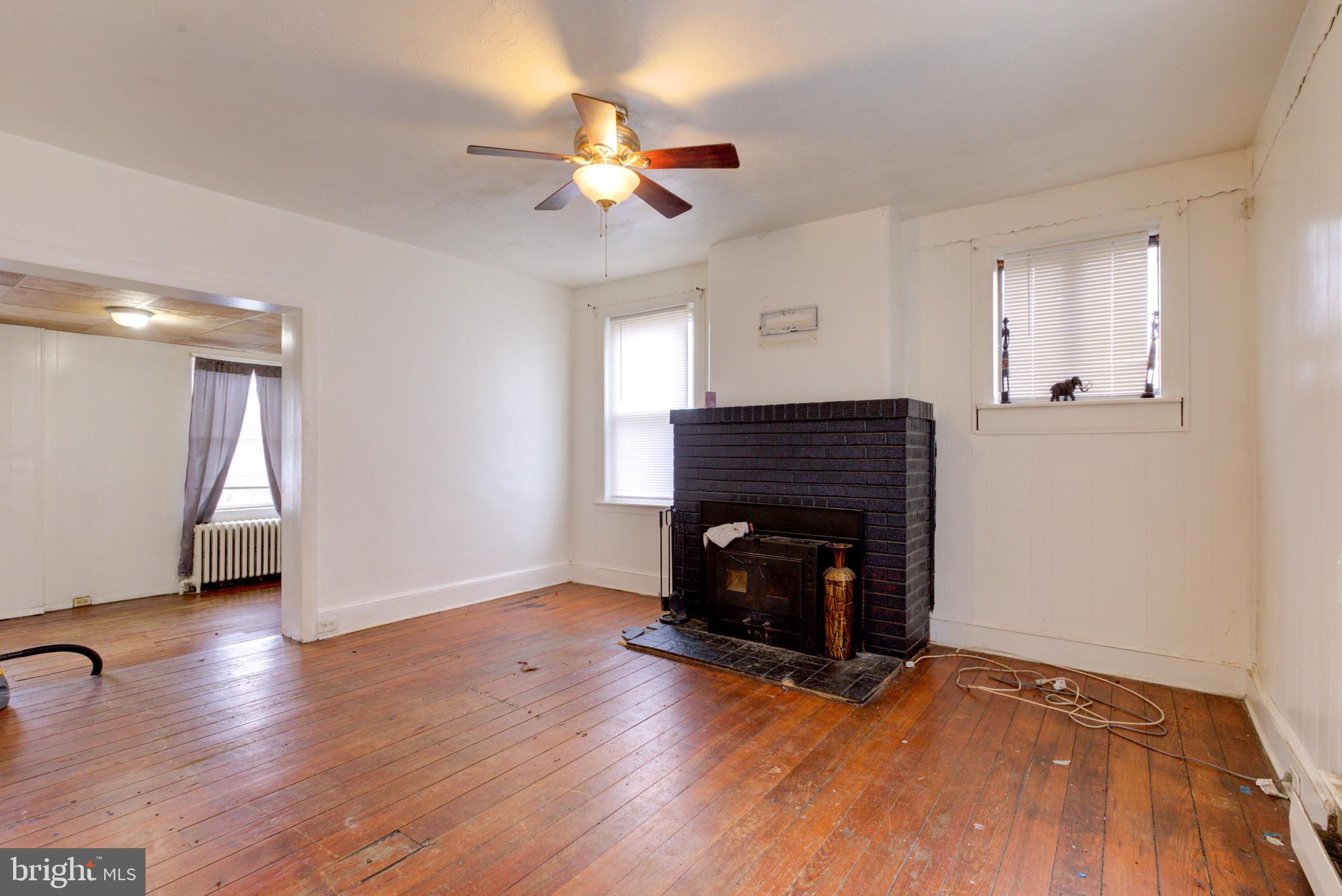 15 7th Street Brookhaven, PA 19015 - Photo 4 of 33 a view of an empty room with wooden floor fireplace and a window