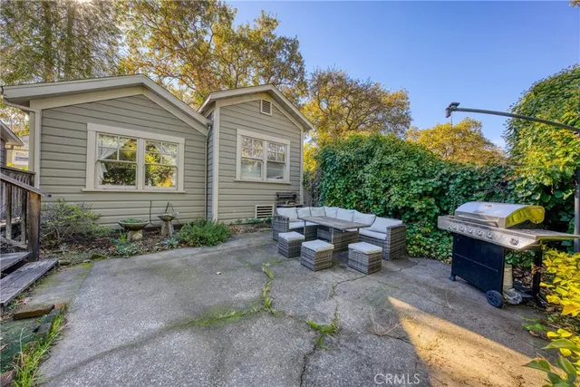 a view of a patio with a table chairs and a backyard