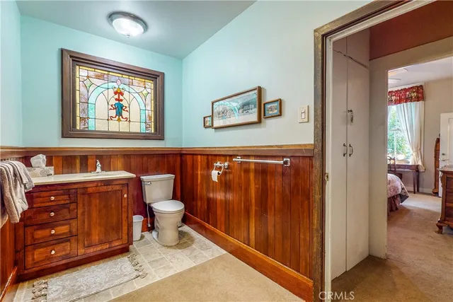 a bathroom with a toilet and a mirror