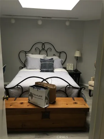 a bedroom with a bed and a mirror