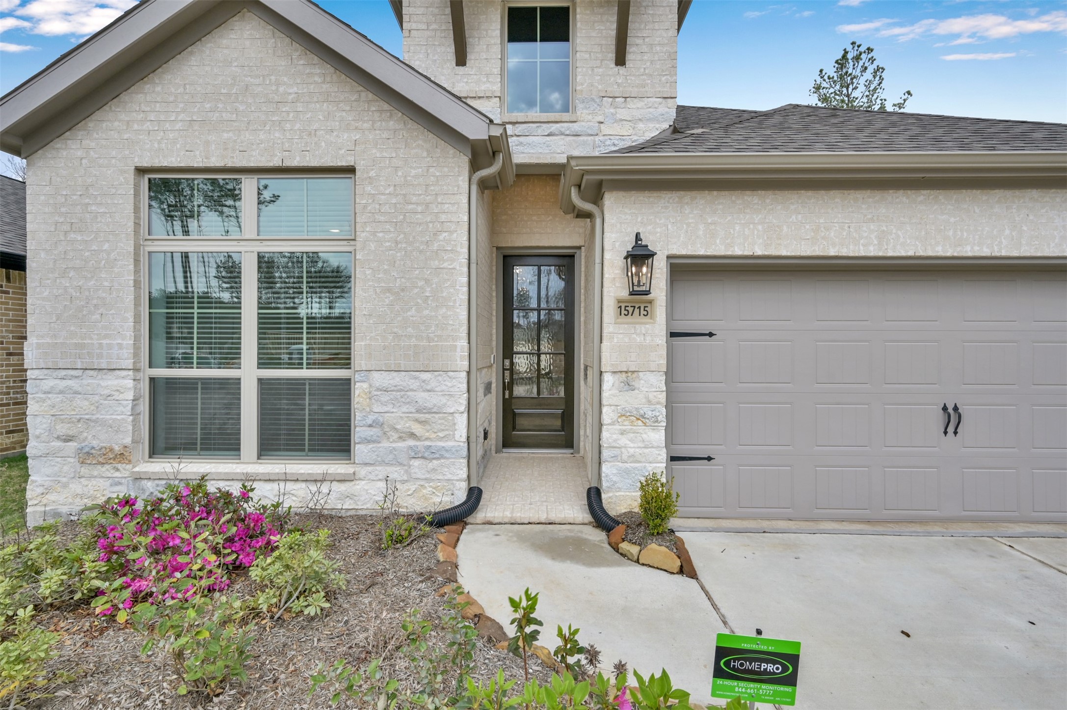 15715 Autumn Sun Conroe, TX 77302 - Photo 2 of 23 a front view of a house with a garden