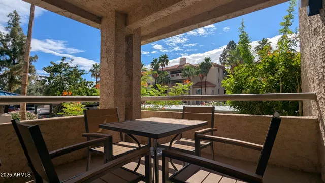 a view of a chairs and table in the balcony