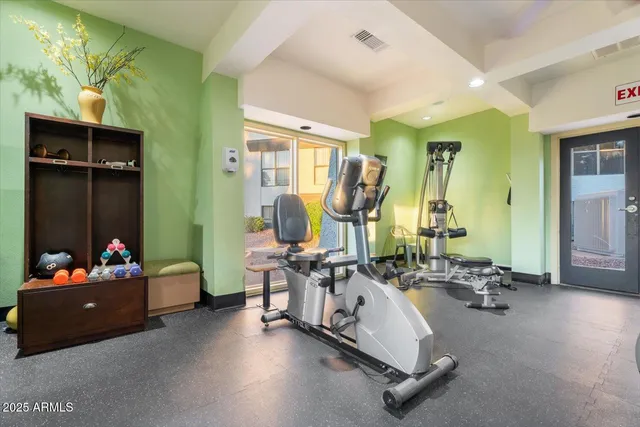 a room with gym equipment and a large window