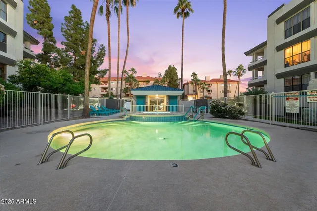 a swimming pool with outdoor seating and yard