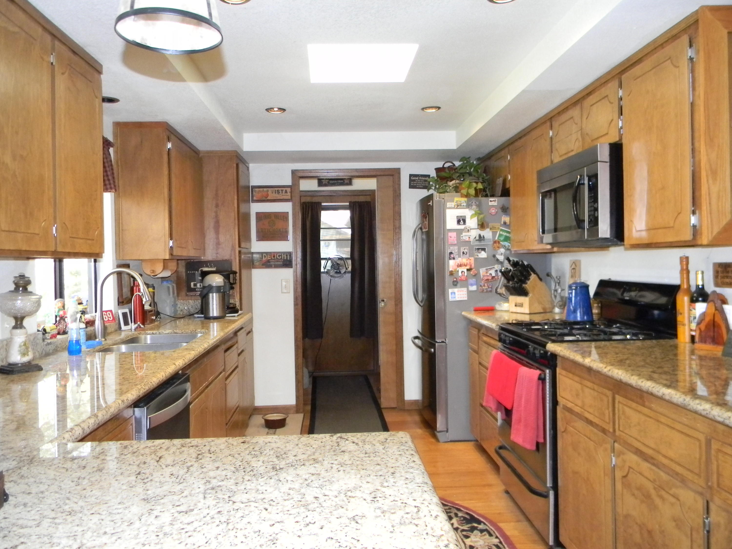 40992 Meadow Drive Three Rivers, CA 93271 - Photo 22 of 29 a kitchen with stainless steel appliances granite countertop sink stove refrigerator and cabinets
