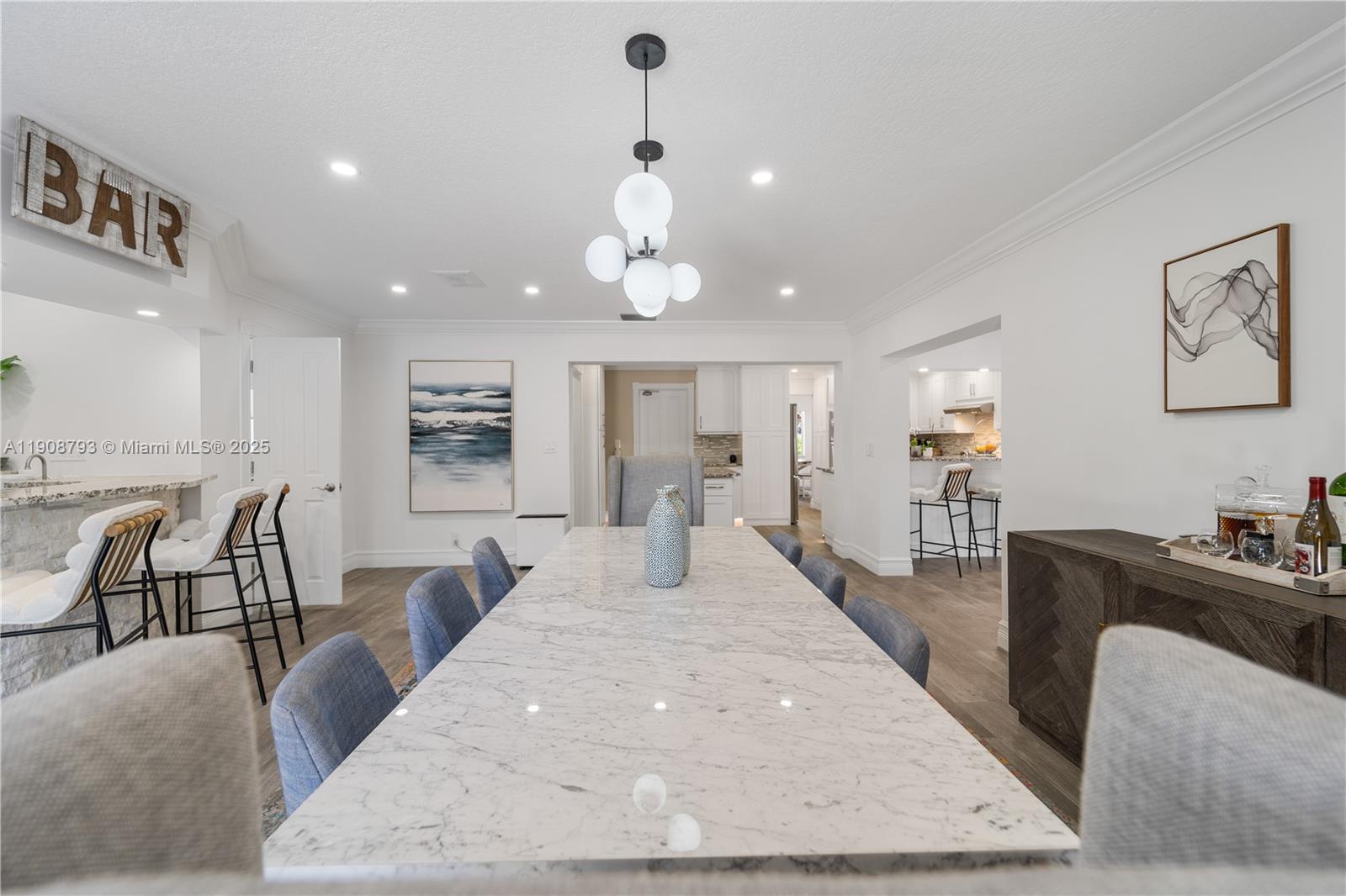 4011 Northeast 26th Avenue Lighthouse Point, FL 33064 - Photo 11 of 35 a dining room with wooden floor and large windows