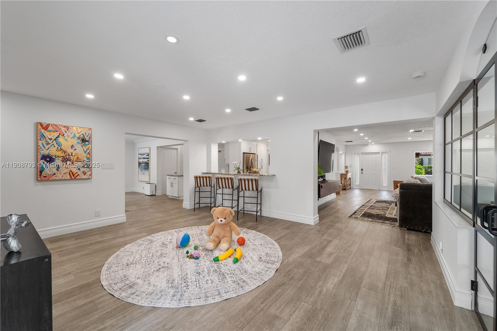 4011 Northeast 26th Avenue Lighthouse Point, FL 33064 - Photo 14 of 35 a living room with furniture and a wooden floor