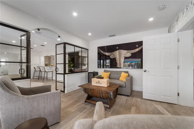 a living room with furniture and a glass door