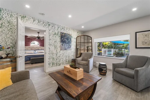 a living room with furniture and a large window