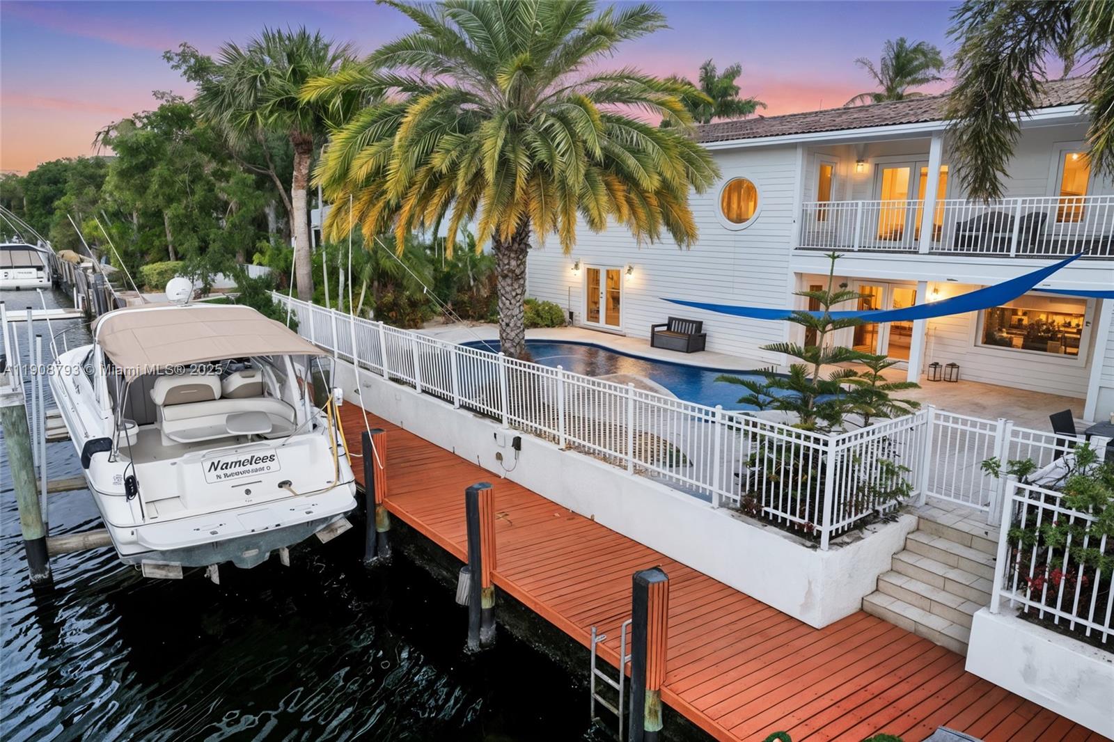 4011 Northeast 26th Avenue Lighthouse Point, FL 33064 - Photo 2 of 35 a balcony with table and chairs