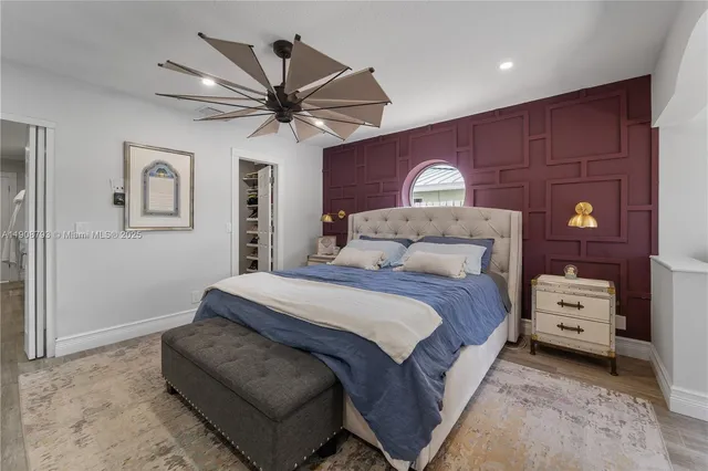 a spacious bedroom with a bed and a chandelier