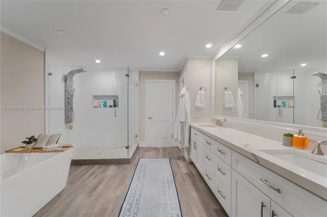 a large bathroom with a sink a large mirror and a shower