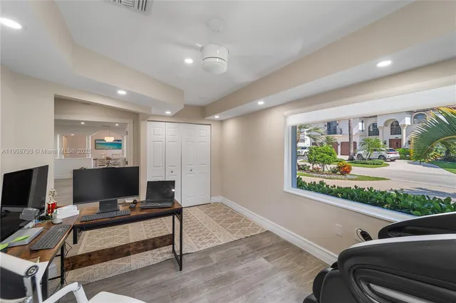 a living room with patio furniture and a flat screen tv