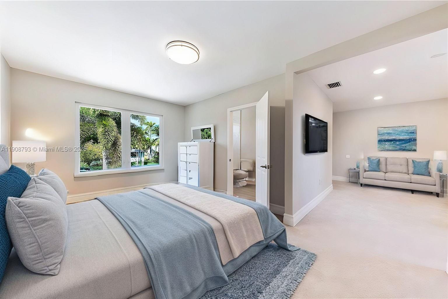 4011 Northeast 26th Avenue Lighthouse Point, FL 33064 - Photo 30 of 35 a bedroom with a large bed and a large window