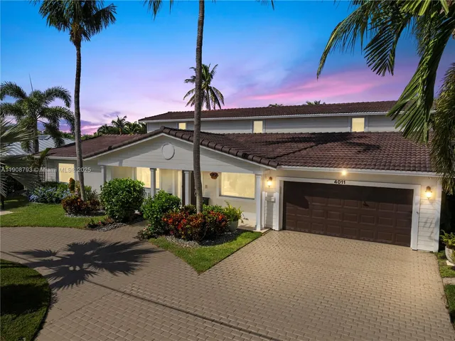 a front view of a house with a garden and a yard
