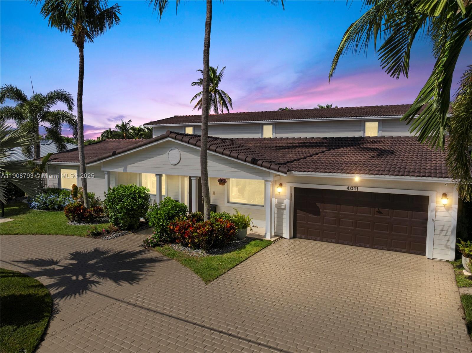 4011 Northeast 26th Avenue Lighthouse Point, FL 33064 - Photo 35 of 35 a front view of a house with a garden and a yard