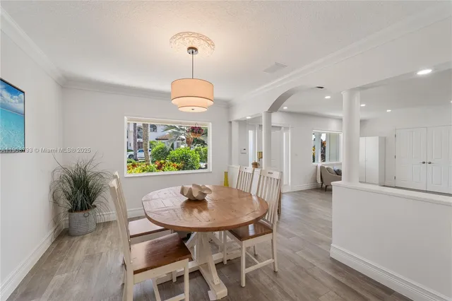 a view of a dining room that has a table and chairs in it