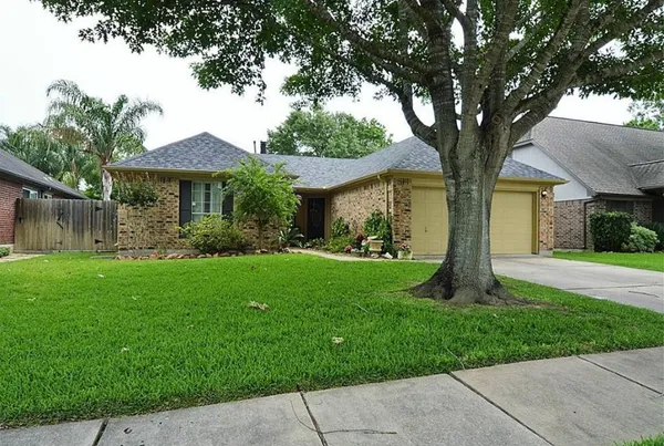 a front view of house with a garden