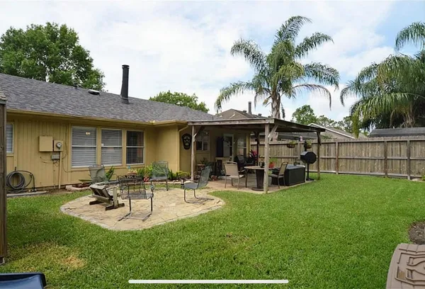a view of a house with backyard porch and sitting area