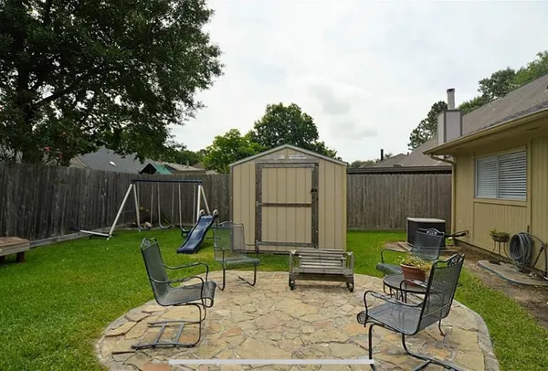 a view of a backyard with furniture and a slide