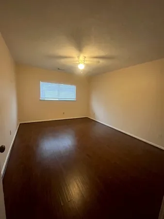 a view of room and hall with wooden floor