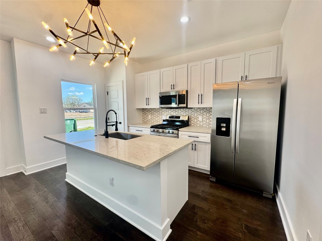 6928 Paris Street, Unit A Houston, TX 77021 - Photo 5 of 20 a kitchen with stainless steel appliances a refrigerator sink and microwave