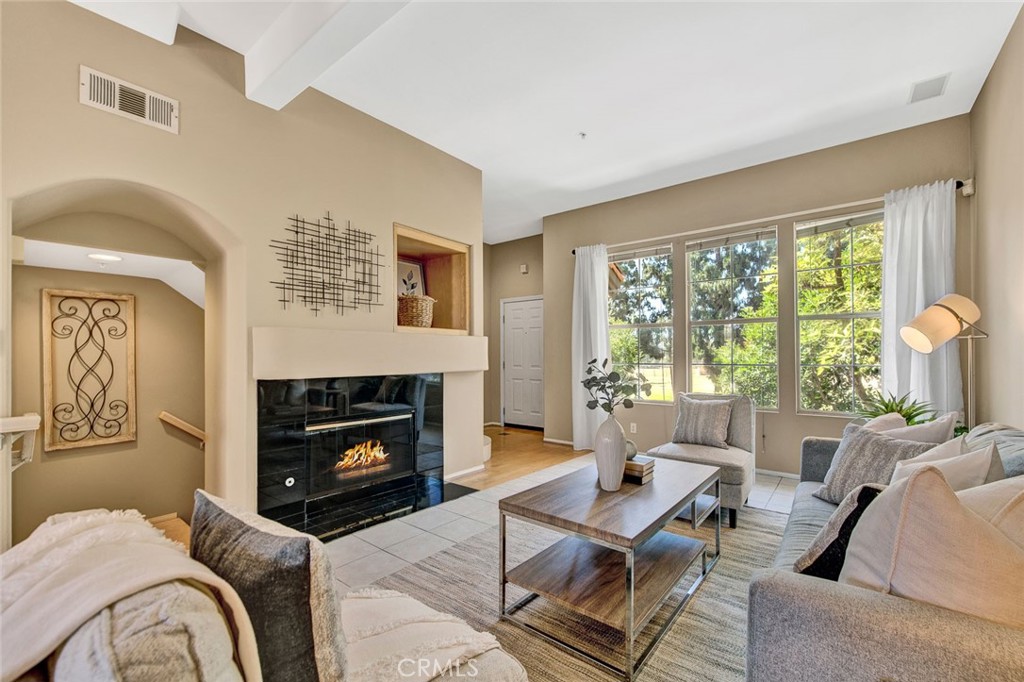 2830 Ballesteros Lane Tustin, CA 92782 - Photo 3 of 28 a living room with furniture a fireplace and a large window