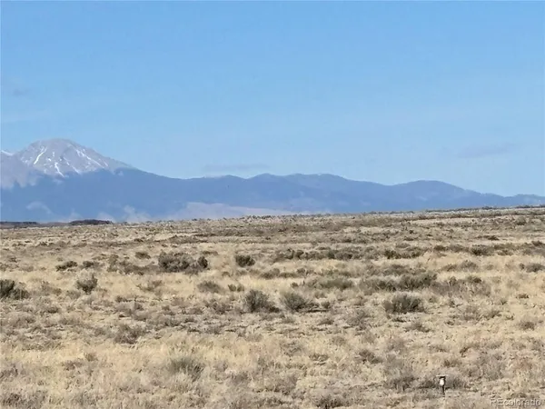 a view of a large mountain with mountains in the background