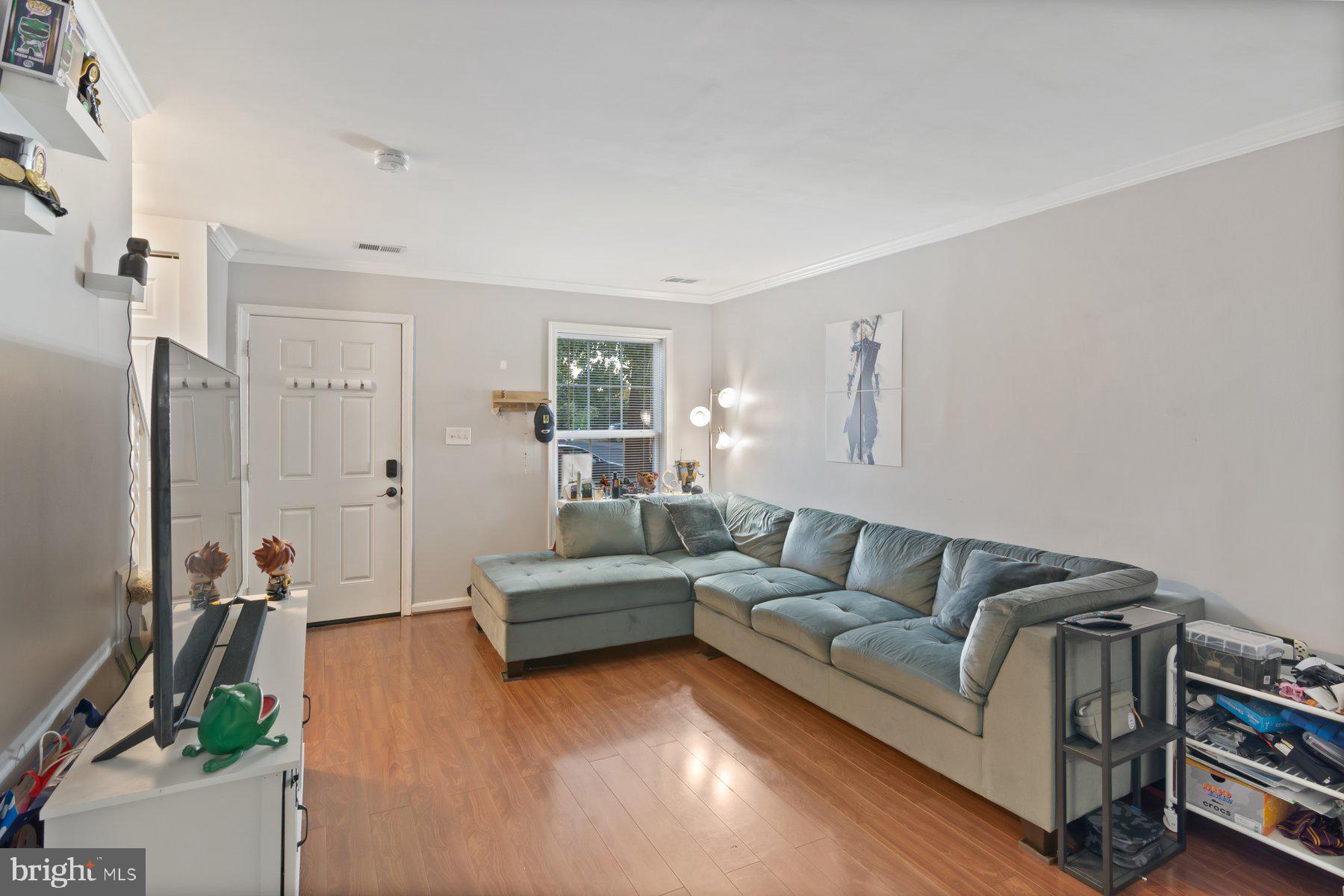 584 Cotswold Court Frederick, MD 21703 - Photo 4 of 21 a living room with furniture and a flat screen tv